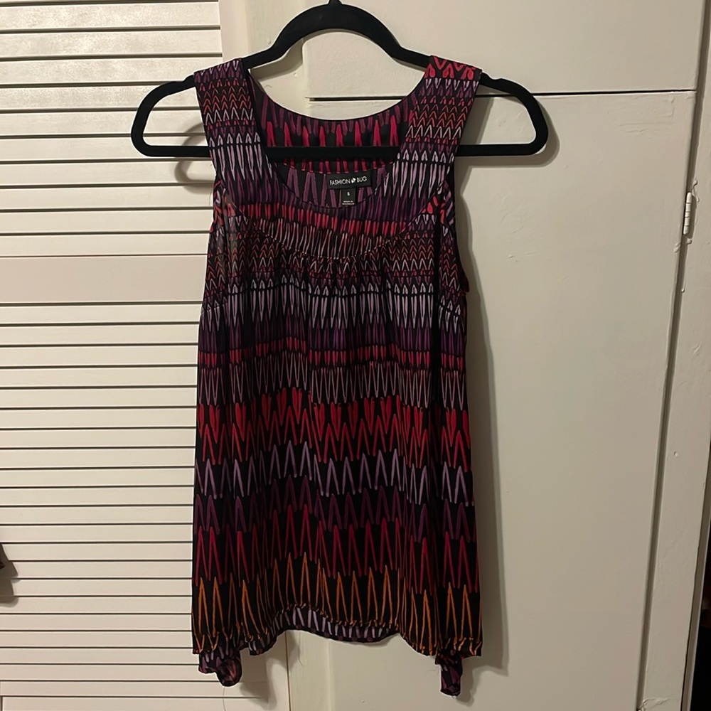 Sleeveless silky material top. Long so will cover your butt. fashion Bug. Size S